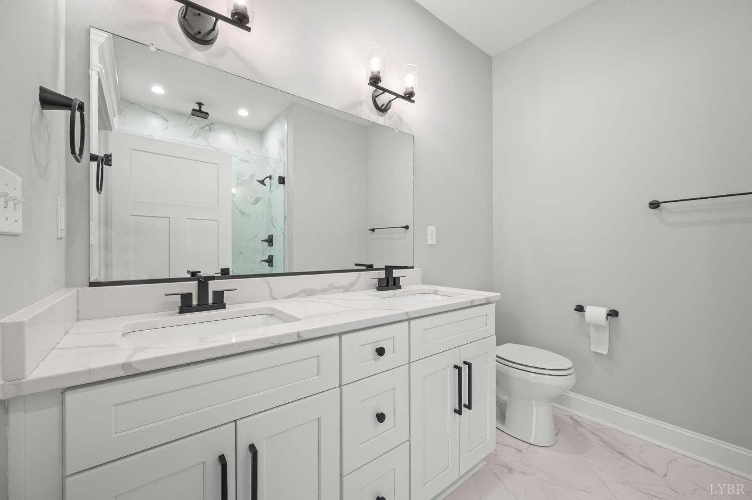 1034 North Westyn Loop Forest, VA 24551 - Photo 19 of 57 a bathroom with a granite countertop sink a toilet and a mirror