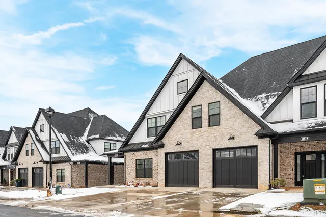 a view of a house with a wooden fence