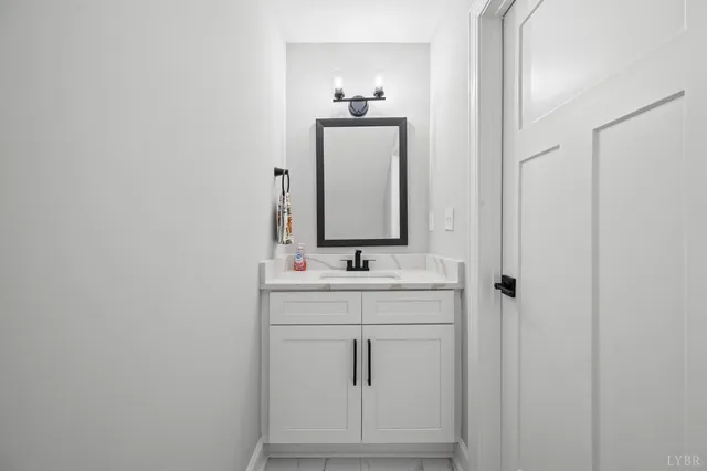 a view of kitchen with refrigerator and wooden floor