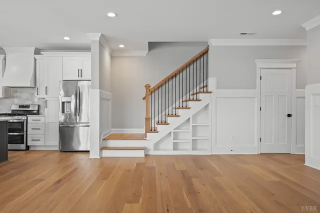 a view of empty room with wooden floor and window