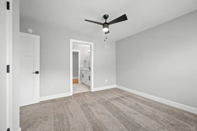 a view of a livingroom with a ceiling fan and window