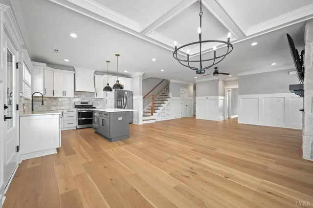 a kitchen with white cabinets and a window