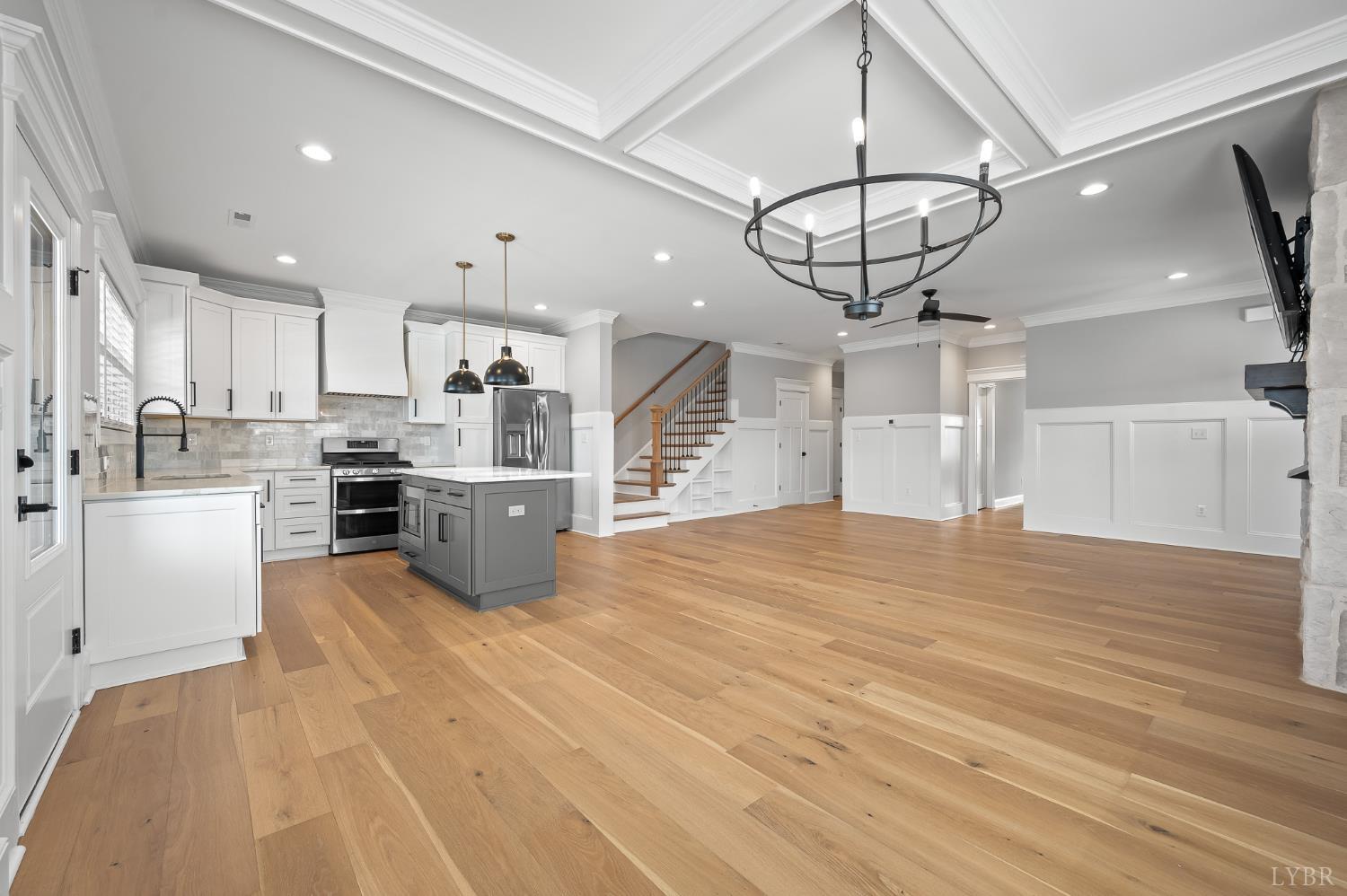 1034 North Westyn Loop Forest, VA 24551 - Photo 10 of 57 a large kitchen with kitchen island a stove a sink dishwasher and white cabinets with wooden floor