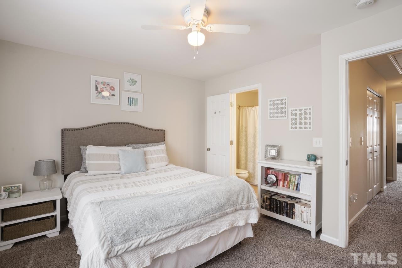 2710 Chilton Place Raleigh, NC 27616 - Photo 14 of 25 a bedroom with a bed and a chandelier