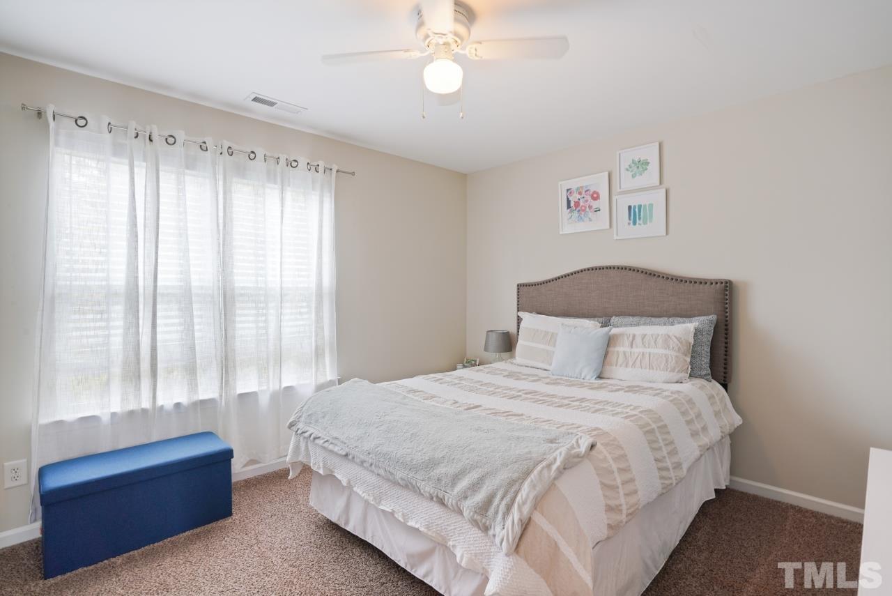 2710 Chilton Place Raleigh, NC 27616 - Photo 15 of 25 a bedroom with a bed and a window
