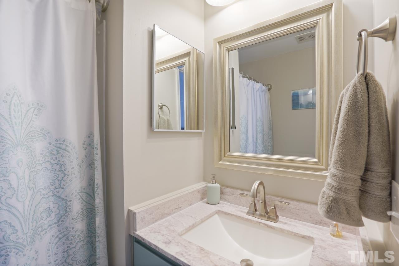 2710 Chilton Place Raleigh, NC 27616 - Photo 16 of 25 a bathroom with a granite countertop sink and a mirror