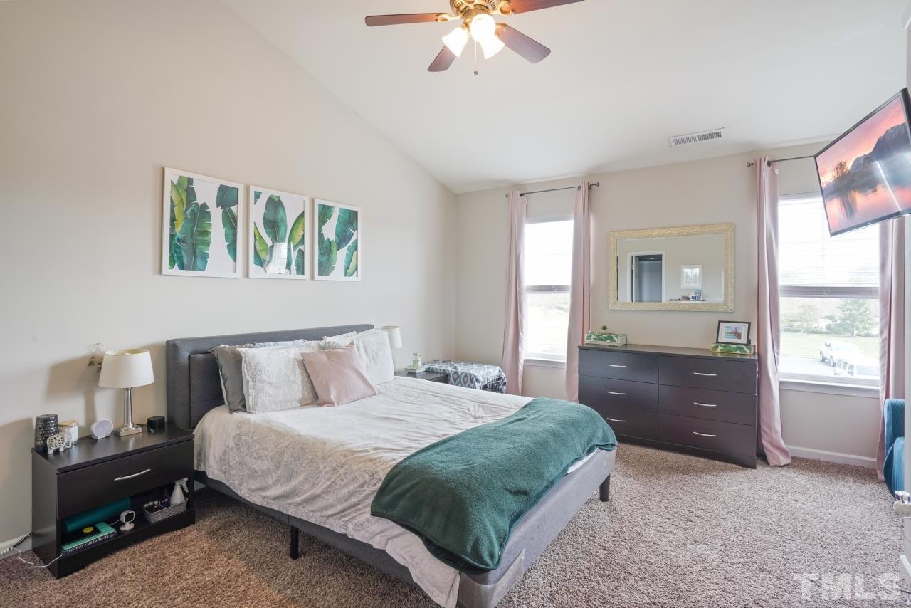 2710 Chilton Place Raleigh, NC 27616 - Photo 17 of 25 a bedroom with a bed and a chandelier