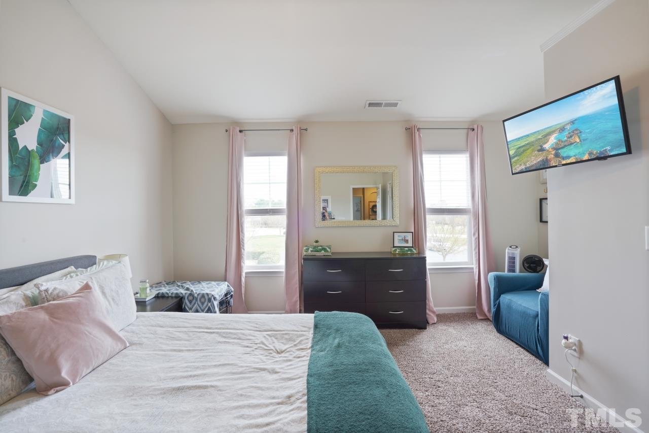 2710 Chilton Place Raleigh, NC 27616 - Photo 18 of 25 a bedroom with a bed and furniture