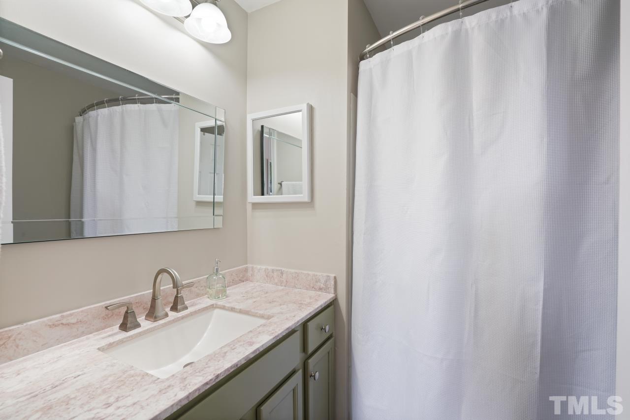 2710 Chilton Place Raleigh, NC 27616 - Photo 19 of 25 a bathroom with a granite countertop sink and a mirror