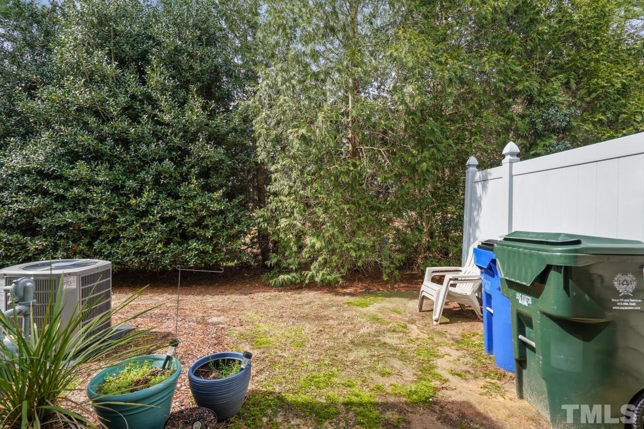2710 Chilton Place Raleigh, NC 27616 - Photo 21 of 25 a view of a backyard with plants and a patio