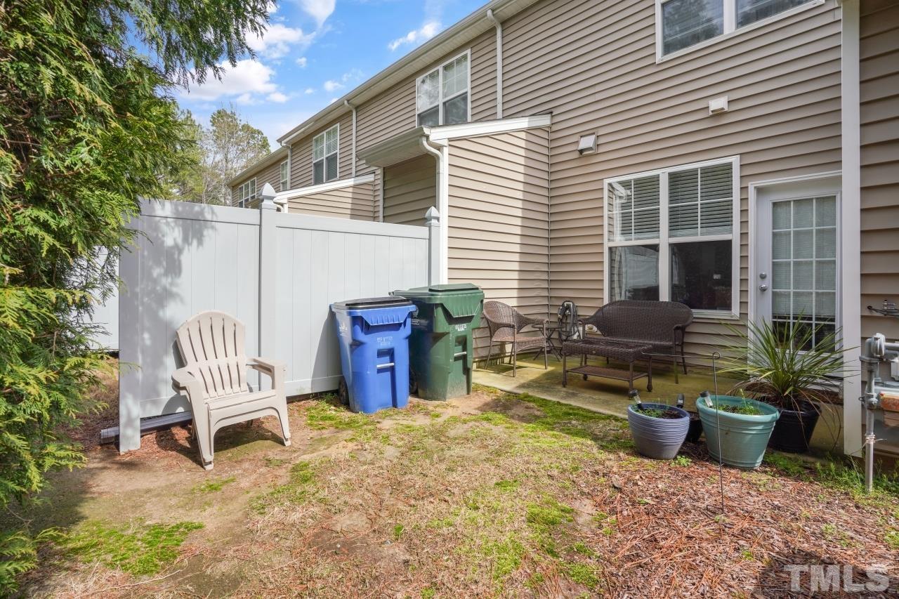 2710 Chilton Place Raleigh, NC 27616 - Photo 22 of 25 a view of a chair and tables in the back yard of the house