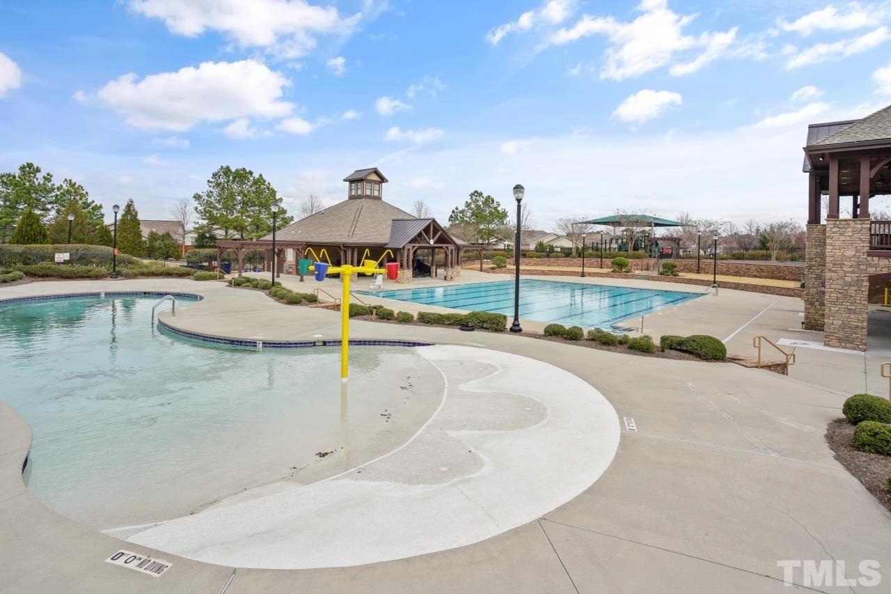 2710 Chilton Place Raleigh, NC 27616 - Photo 24 of 25 a view of a swimming pool with a patio and a garden