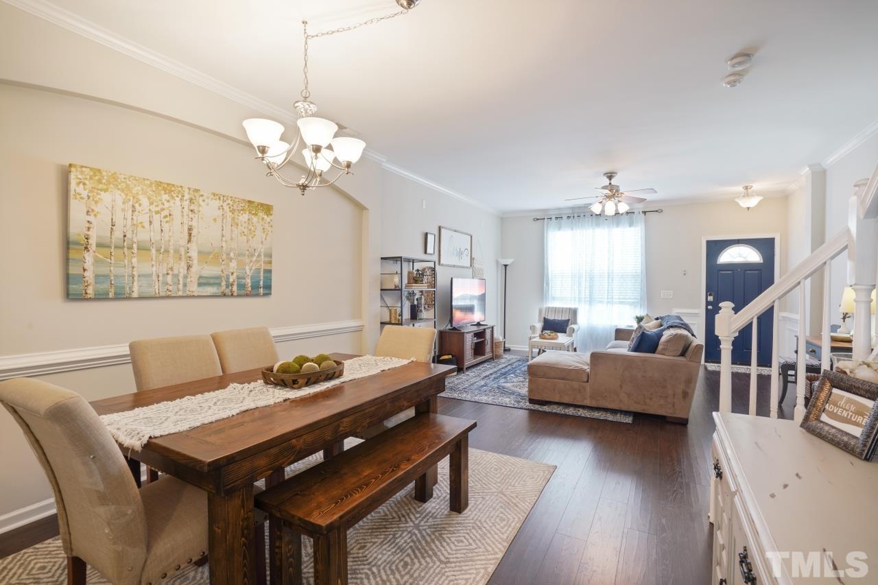 2710 Chilton Place Raleigh, NC 27616 - Photo 6 of 25 a living room with furniture a chandelier and a dining room