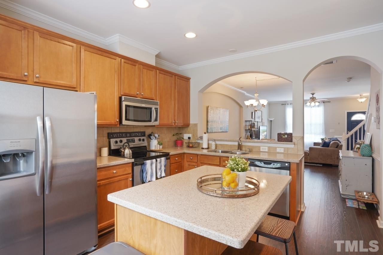 2710 Chilton Place Raleigh, NC 27616 - Photo 9 of 25 a large kitchen with a table chairs and refrigerator