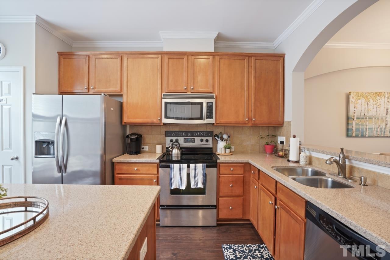 2710 Chilton Place Raleigh, NC 27616 - Photo 10 of 25 a kitchen with stainless steel appliances granite countertop a refrigerator stove microwave and sink