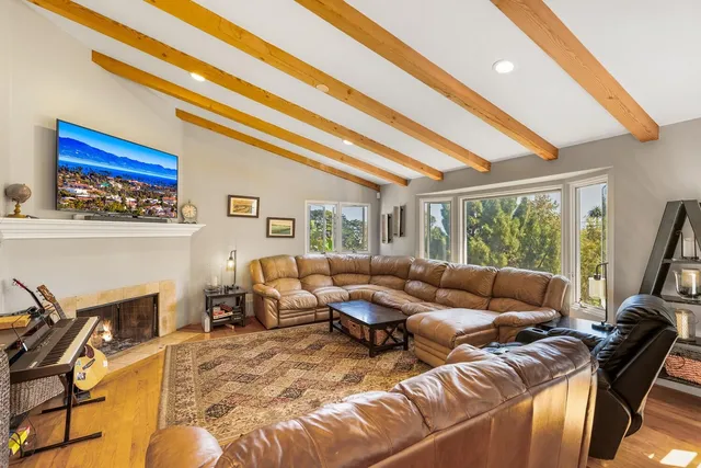 a living room with furniture a chandelier and a floor to ceiling window