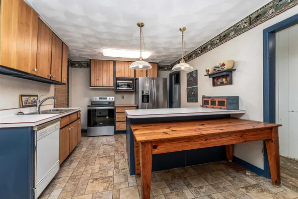 a kitchen with stainless steel appliances granite countertop a sink and cabinets