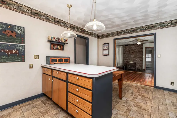 a room with stainless steel appliances granite countertop a sink and a refrigerator