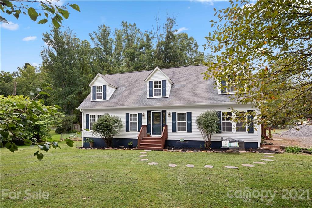 101 McFalls Road Asheville, NC 28805 - Photo 1 of 21 a front view of a house with a garden