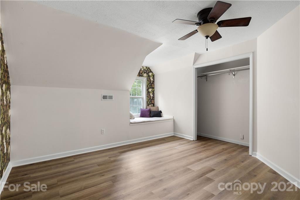 101 McFalls Road Asheville, NC 28805 - Photo 15 of 21 an empty room with wooden floor chandelier fan and windows