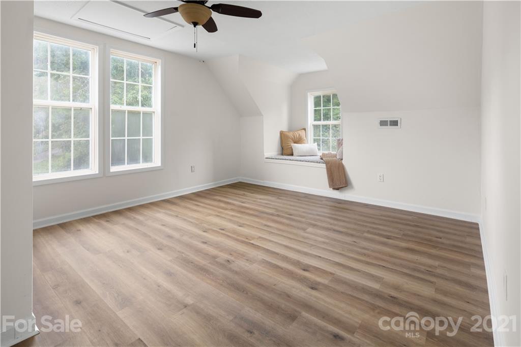 101 McFalls Road Asheville, NC 28805 - Photo 16 of 21 an empty room with wooden floor chandelier fan and windows