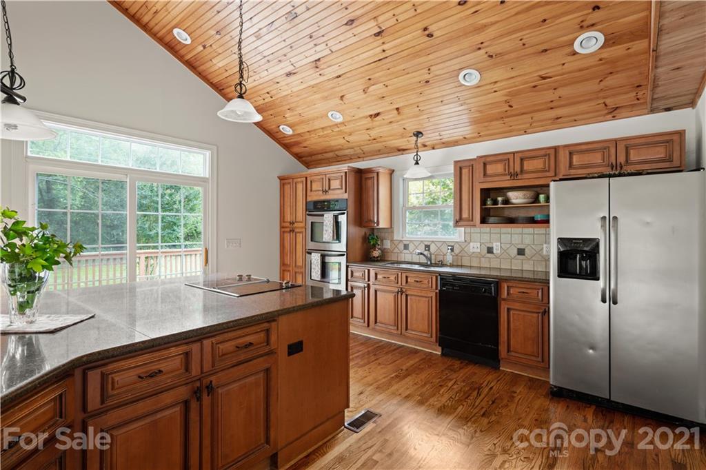 101 McFalls Road Asheville, NC 28805 - Photo 3 of 21 a kitchen with stainless steel appliances granite countertop a sink a stove and a refrigerator