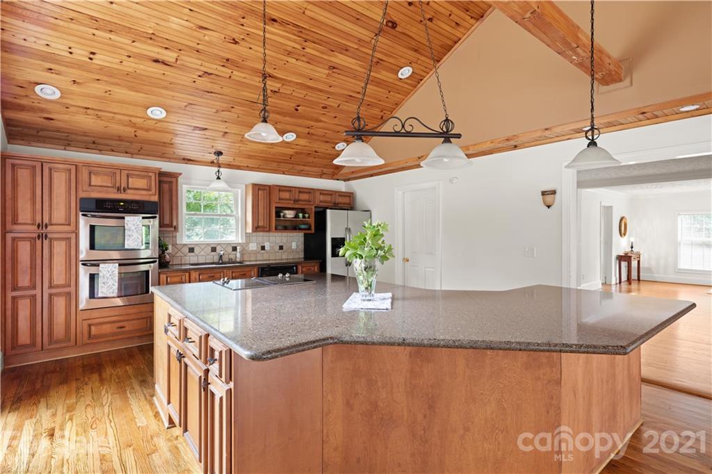 101 McFalls Road Asheville, NC 28805 - Photo 4 of 21 a kitchen with stainless steel appliances granite countertop a sink a stove cabinets counter space and a window