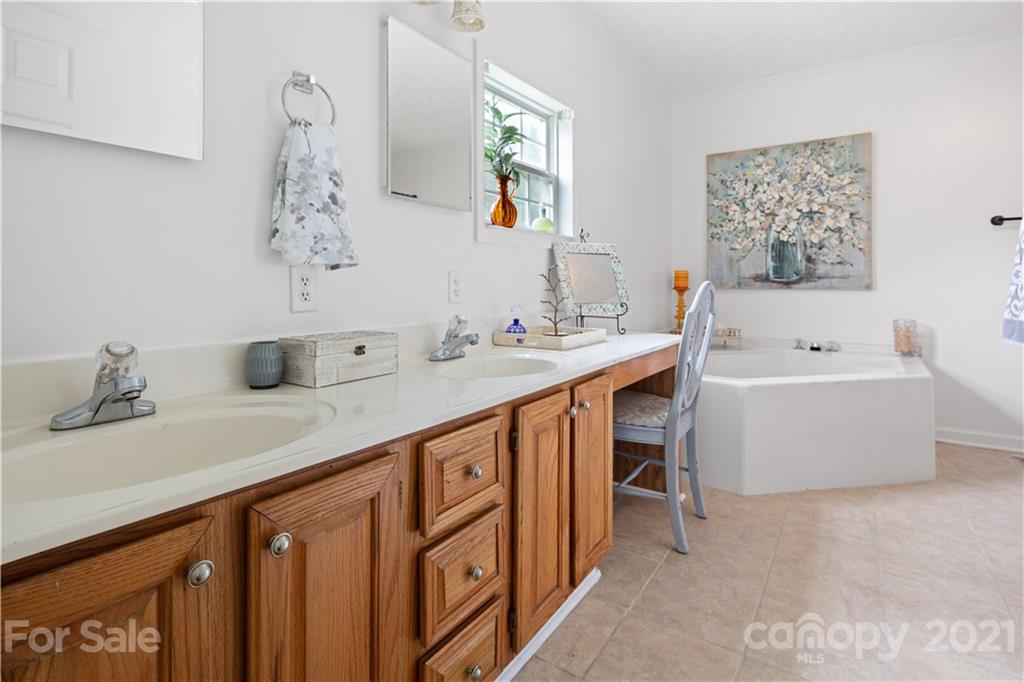 101 McFalls Road Asheville, NC 28805 - Photo 9 of 21 a bathroom with a tub sink and mirror