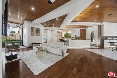 a large room with lots of white furniture