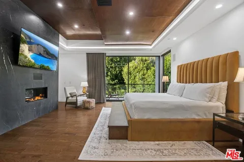 a bedroom with furniture and a large window