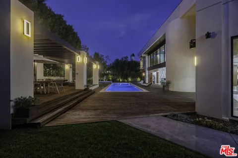 a view of a patio with couches table and chairs and potted plants