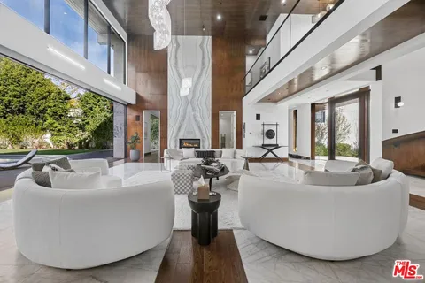 a living room with furniture and a ceiling fan