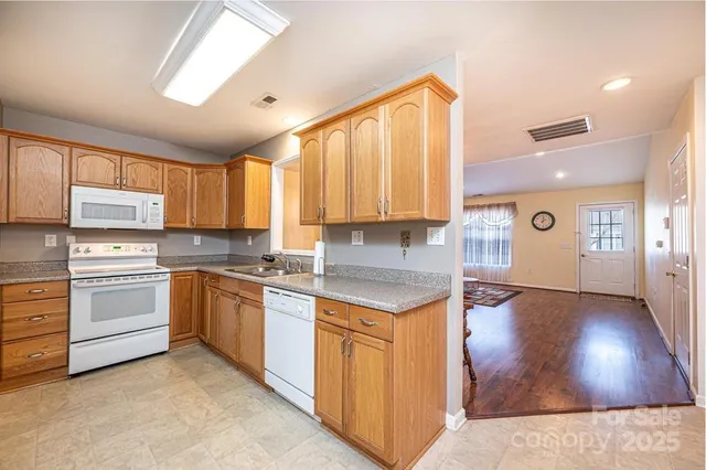 a kitchen with a stove a sink and a window