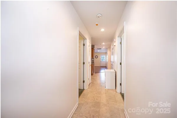 a hallway with a closet and a bathroom