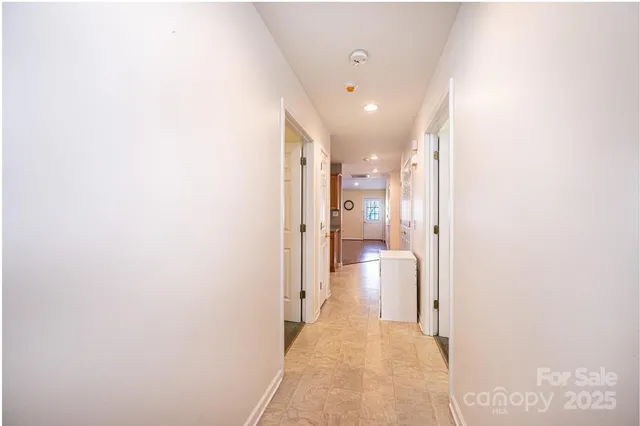 a hallway with a closet and a bathroom