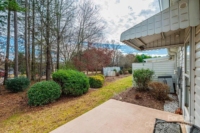 a view of a patio with a table and chairs next to a yard