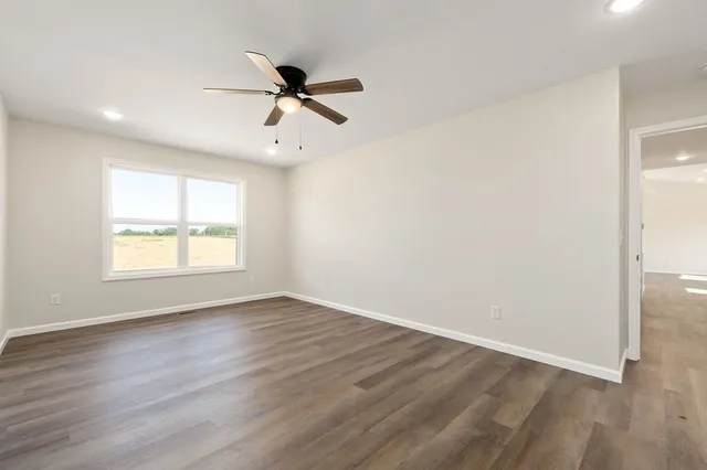 an empty room with wooden floor & closet