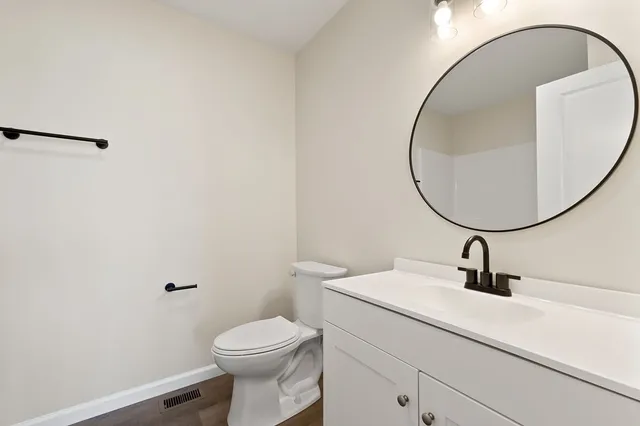 a bathroom with a sink a mirror and a toilet