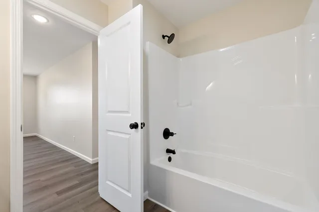 a bathroom with a bathtub and a shower