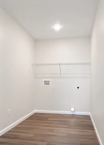 a view of a room with wooden floor