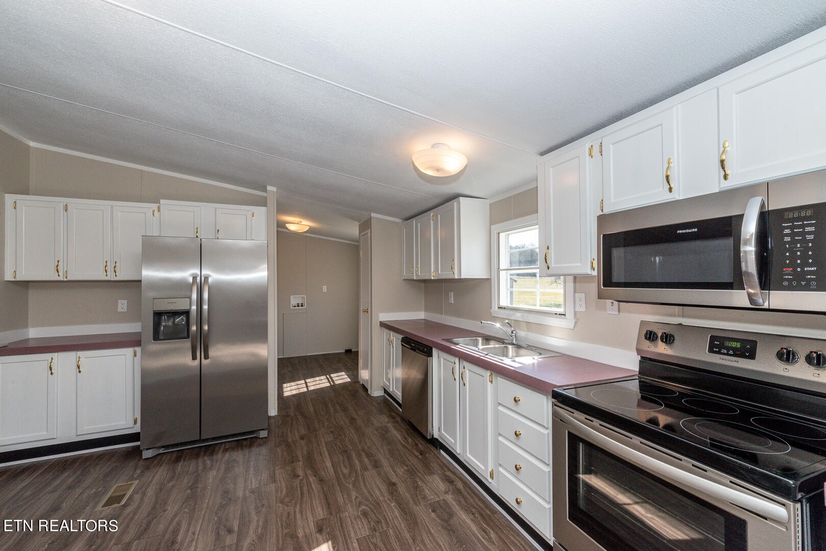 1602 Fork Creek Road Philadelphia, TN 37846 - Photo 8 of 26 a large kitchen with cabinets and stainless steel appliances