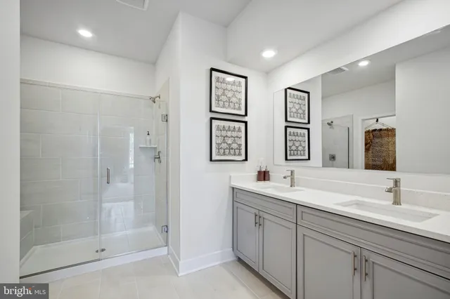 a bathroom with double sink and a mirror