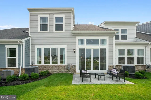 a view of a house with a backyard and a large window