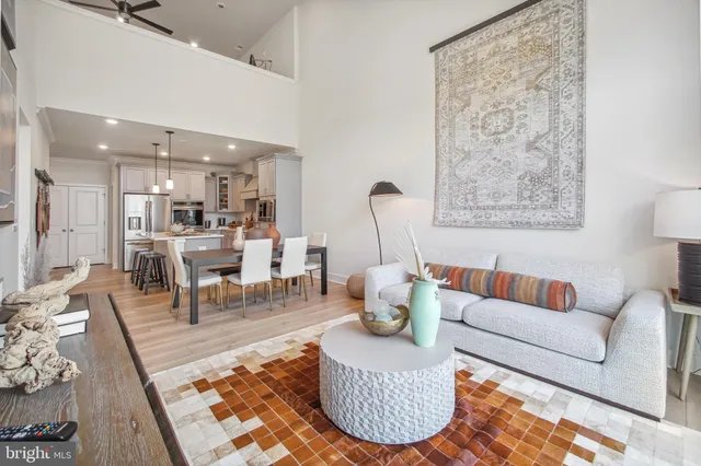 a living room with furniture a rug and a table