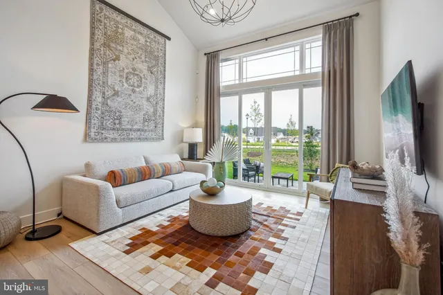 a living room with furniture large window and a flat screen tv