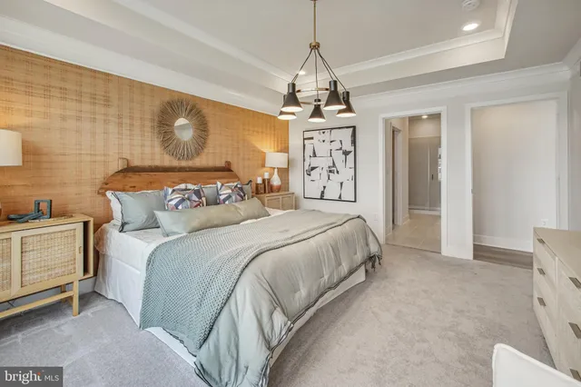 a spacious bedroom with a bed and a chandelier