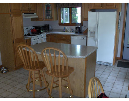 23 Great Road Maynard, MA 01754 - Photo 6 of 11 a kitchen with stainless steel appliances granite countertop a sink a stove a refrigerator cabinets and a dining table