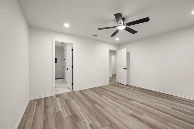 a view of an empty room and wooden floor
