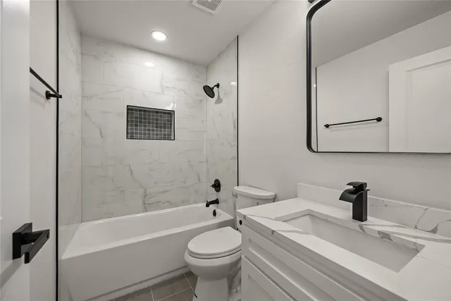 a bathroom with a sink a toilet and a bathtub