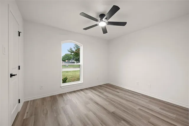 wooden floor in an empty room with a window
